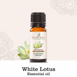 May include: A brown glass bottle of White Lotus essential oil with a black cap. The bottle label features a white lotus flower and the text "Shudh Aura Ethically Sourced White Lotus Oil Nelumbo nucifera 100% Pure & Natural Therapeutic Grade".