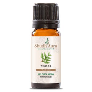 May include: A brown glass bottle with a black cap, labelled "Shudh Aura - Ethically Sourced - Thuja Oil - Thuja Orientali - 100% Pure & Natural - Therapeutic Grade".