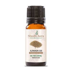 Könnte beinhalten: Eine braune Glasflasche mit schwarzem Verschluss, die Ajwain-Öl enthält. Das Etikett ist weiß mit grünem Text und einem grünen Blattdesign. Der Text auf dem Etikett lautet "Shudh Aura - Ethically Sourced", "Ajwain Oil", "Trachyspermum ammi", "100% Pure & Natural" und "Therapeutic Grade".