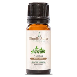 May include: An amber glass bottle of thyme oil with a black cap. The label displays "Shudh Aura - Ethically Sourced" and "Thyme Oil Thymus vulgaris". The label also states "100% Pure & Natural Therapeutic Grade".