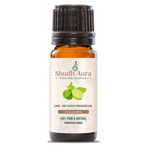 May include: A brown glass bottle of Shudh Aura lime oil. The label features the brand name, a lime and mint illustration, and the text "100% Pure & Natural". The bottle has a black cap and is labeled "Citrus aurantifolia".