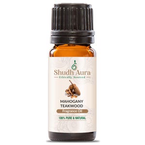 May include: A brown glass bottle with a black cap, labelled "Shudh Aura - Ethically Sourced" and "Mahogany Teakwood Fragrance Oil 100% Pure & Natural". The label also features a green leaf design and a drawing of mahogany teakwood.