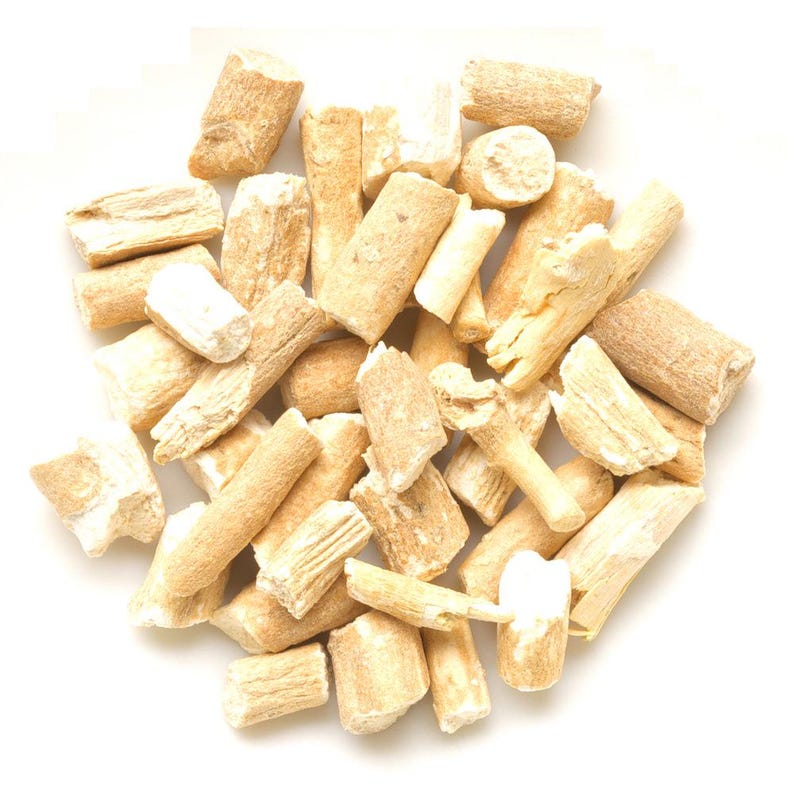 May include: A collection of small, dried, light beige woody root segments with a fibrous, uneven texture. The pieces are cylindrical and irregular in shape, displaying a natural, matte finish with varying shades of tan and cream throughout the pile.