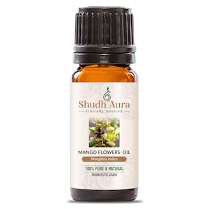 May include: A brown glass bottle with a black cap, labelled "Shudh Aura Ethically Sourced Mango Flowers Oil Mangifera indica 100% PURE & NATURAL THERAPEUTIC GRADE".