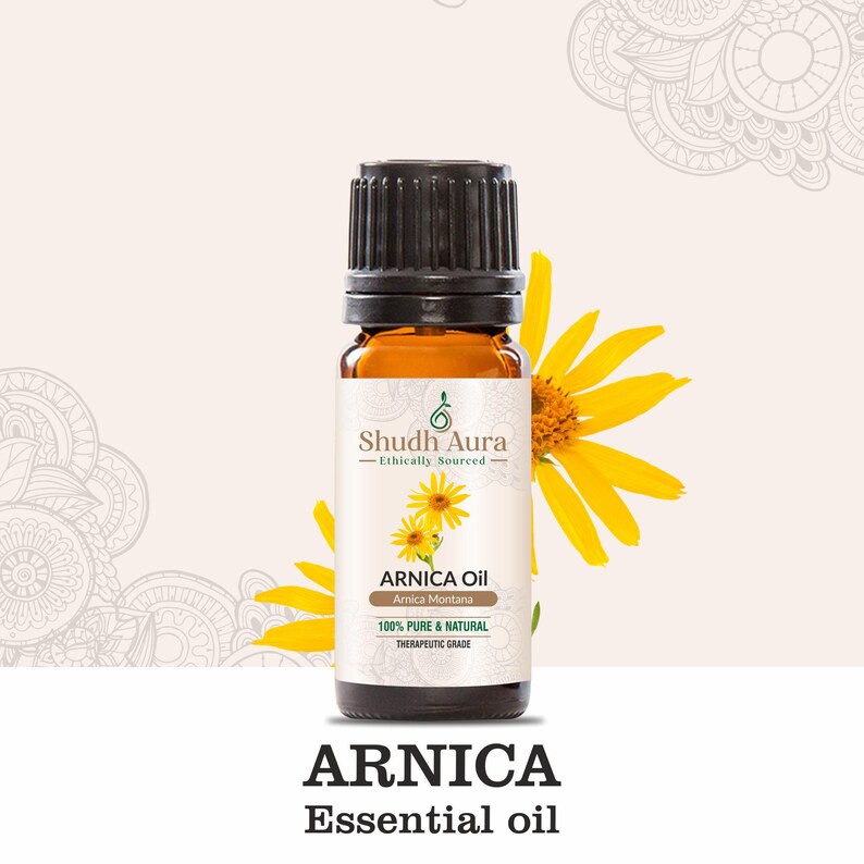 May include: A brown glass bottle of Arnica essential oil with a black cap. The bottle label is white with green and brown accents and reads "Shudh Aura Ethically Sourced Arnica Oil Amica Montana 100% Pure & Natural Therapeutic Grade".