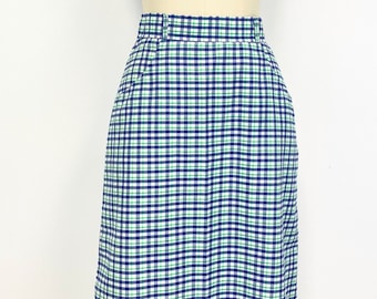 May include: A white, blue, and green plaid skirt. The skirt is knee-length and has a straight silhouette.