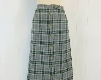 May include: A long gray and green plaid skirt with a button front closure.