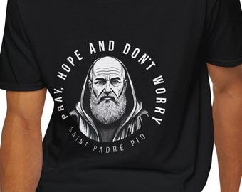 May include: Black t-shirt with a white circle graphic featuring a drawing of a man with a beard and the text "Pray, Hope and Don't Worry Saint Padre Pio".
