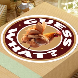May include: A round sticker with a brown border and the words "GUESS WHAT?" in white. Inside the circle is a detailed illustration of a brown and orange chicken.