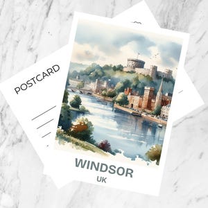 May include: A rectangular postcard featuring a watercolor illustration of Windsor Castle overlooking a river. The word POSTCARD is printed on the left side, while WINDSOR UK is printed in bold gray text at the bottom of the white-bordered image.