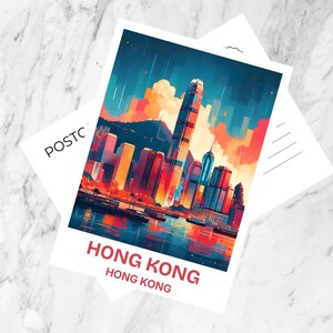 May include: A rectangular postcard featuring a vibrant, stylized illustration of the Hong Kong skyline at sunset with deep blues, oranges, and reds. The text HONG KONG is printed in bold red letters at the bottom, with POSTCARD visible on the side.