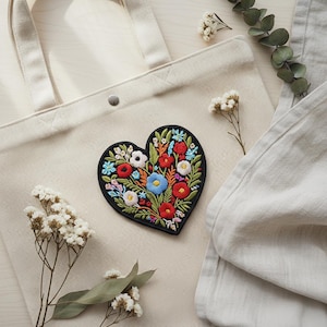 May include: A white ceramic mug with a black handle and the text "But First, Coffee" in a handwritten style. The mug is on a white surface. The mug is 10 cm tall.