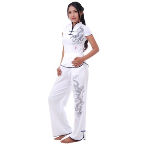 May include: White pajama set with a mandarin collar and short sleeves. The top and pants feature a black dragon design.