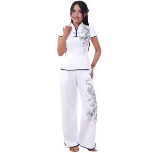 May include: White pants with a black dragon design and a white shirt with a black dragon design and a mandarin collar.