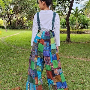 May include: Patchwork wide-leg overalls with a colorful, multi-patterned design. The overalls have adjustable straps and a relaxed fit.