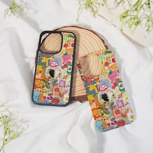 May include: Two colorful phone cases with a whimsical design. The cases feature a collage of cartoon animals, fruits, and other playful elements. One case has a black border. The design includes giraffes, strawberries, and rainbows.