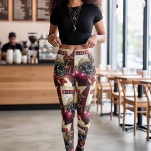 May include: High-waisted leggings featuring a repeating graphic print of the word Lilith, dark red candles, and circular occult-style sigils on a beige background. The leggings are paired with a plain black short-sleeved crop top and black boots.
