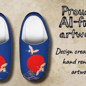May include: Pair of blue slippers with a white interior, featuring a red sun and crane artwork. The design includes the text "Proudly AI-free artwork" and "Design created from hand rendered artwork".