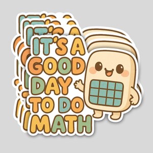 May include: A stack of stickers with a cartoon calculator character and the text "IT'S A GOOD DAY TO DO MATH" in orange, green, and blue. The calculator has a smiling face and is light beige with a blue grid.