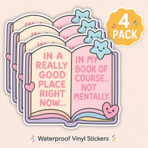 May include: A 4-pack of waterproof vinyl stickers featuring an open book illustration with pastel colors. The text reads: IN A REALLY GOOD PLACE RIGHT NOW... IN MY BOOK OF COURSE.. NOT MENTALLY. Includes a smiling star and heart icon.