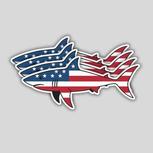 May include: Three shark-shaped stickers with an American flag design. The sharks are white with blue and red stripes and white stars. The stickers are on a gray background.