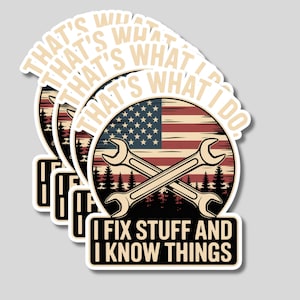 May include: A stack of stickers featuring a design with an American flag, crossed wrenches, and the text "THAT'S WHAT I DO. I FIX STUFF AND I KNOW THINGS." The design is in shades of beige, red, blue, and black.