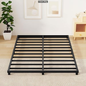 May include: A black metal bed frame with a slatted design. The frame is rectangular and sits on the floor. The text "4 Inch | King" is in the top left corner.