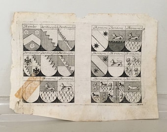 May include: A black and white vintage print of coats of arms. The print features the names Bembo, Bentivoglio, and Benzoni. The print is on a piece of paper with a brown stain.