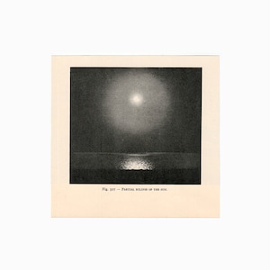 May include: A black and white photograph of a partial solar eclipse. The sun is partially obscured by the moon, casting a shadow on the water below.