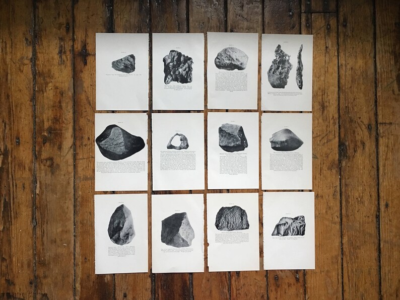 May include: A collection of 12 black and white photographs of different rocks and stones. Each photograph is framed with a white border and is displayed on a wooden surface.