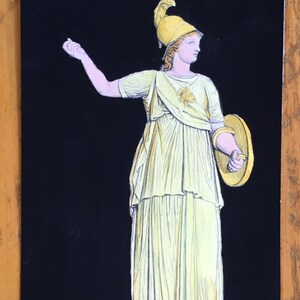 May include: A black and white illustration of a woman wearing a yellow helmet and a yellow dress holding a shield. The woman is standing on a pedestal.