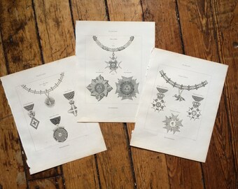 May include: Three black and white illustrations of different types of medals and necklaces. The illustrations are on separate sheets of paper.