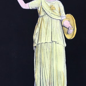 May include: A yellow and white statue of a woman wearing a helmet and holding a shield. The statue is standing on a pedestal.