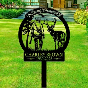 May include: Black metal silhouette of a hunter with a rifle and a deer in a forest setting. The text "In Loving Memory Of" is above the image and "CHARLEY BROWN 1939-2025" is below the image.