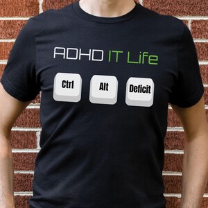 May include: A black t-shirt with the text "ADHD IT Life" and three computer keys labeled "Ctrl", "Alt", and "Deficit".