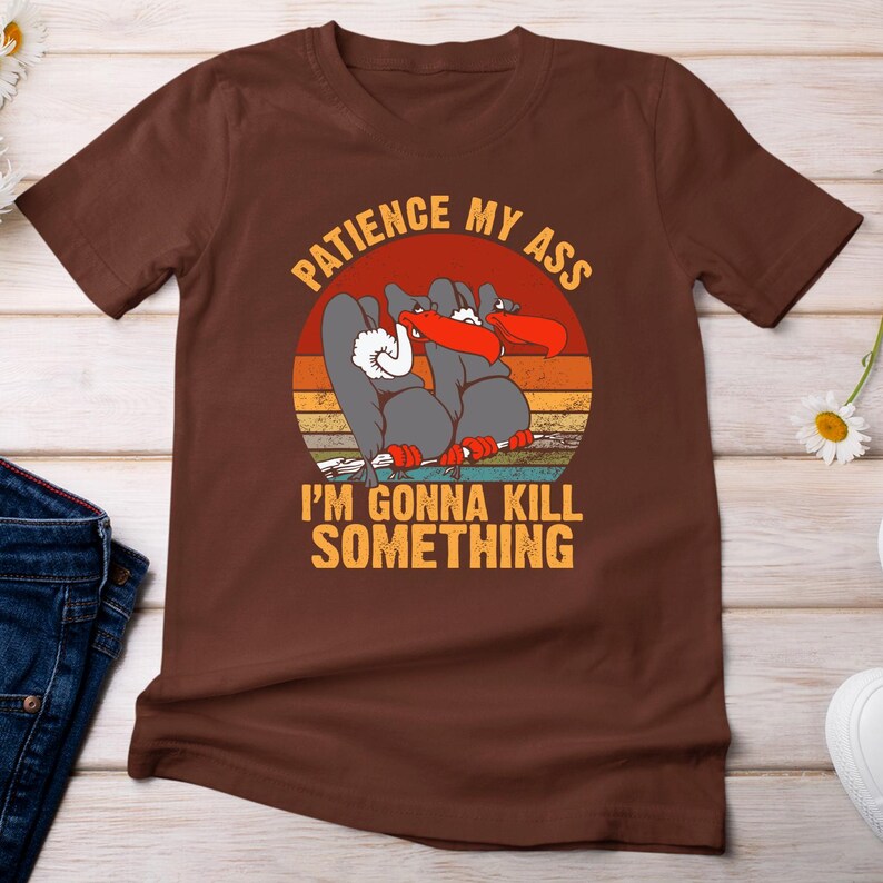 a brown t - shirt with a picture of a cartoon character on it