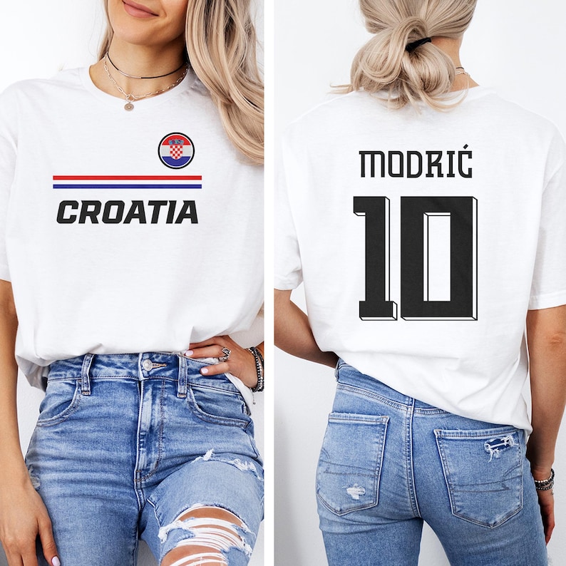 A woman wearing a white t-shirt with the word "Croatia" printed on it, and a number "10" printed on the back. She is also wearing blue jeans.