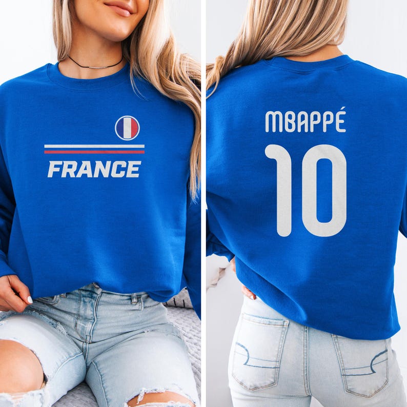 A woman wearing a blue sweatshirt with the word "FRANCE" printed on it, and the number "10" printed on the back.