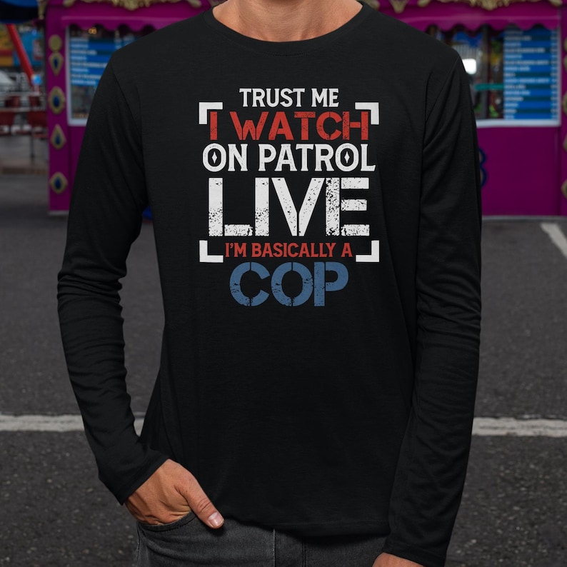 a man in a black shirt is standing in a parking lot