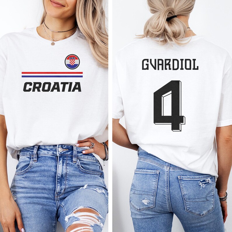 A woman wearing a white t-shirt with the word "Cromia" printed on it, and a number "4" on the back. She is also wearing blue jeans.