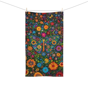 May include: A vibrant towel featuring a butterfly design set against a backdrop of colourful flowers. The butterfly is detailed with intricate patterns and outlined in blue. The floral background includes orange, yellow, pink, and blue blooms.