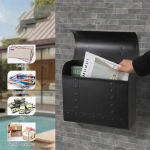 May include: A black metal mailbox mounted on a gray brick wall. The mailbox has a curved top and riveted details. Inside, a magazine with the word "MURUI" is visible, along with a green box. The image also shows examples of items that can be placed in the mailbox, such as letters, magazines, bills, and small packages.