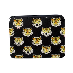 May include: Black zippered pouch with a repeating pattern of yellow and orange tiger faces.