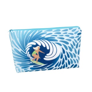 May include: A blue and white zippered pouch with a graphic of a woman surfing a wave. The wave is stylized with a blue and white swirl pattern.