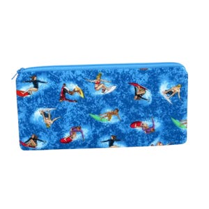 May include: A blue zippered pouch with a repeating pattern of surfers on waves. The surfers are all wearing different colored clothing and are riding different colored surfboards.