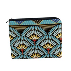 May include: A rectangular zippered pouch with a black zipper and a colorful floral pattern. The pattern features stylized blue, yellow, and red fan-like shapes on a black background. The top border has a geometric design with blue, black, and gold accents.