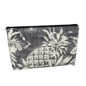May include: Black and white zippered pouch with a pineapple and leaf design.