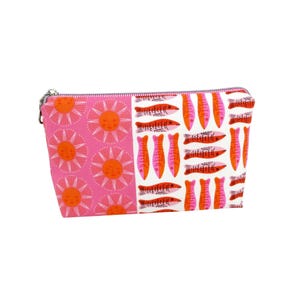 May include: A zippered pouch with a vibrant pattern. One side features pink suns with orange faces, while the other displays orange and pink fish on a white background. The pouch has a silver zipper.