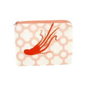 May include: A rectangular, zippered pouch with a coral-colored octopus illustration. The pouch has a light pink background with white quatrefoil and dot patterns. The zipper and trim are also coral-colored.