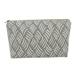 May include: A beige zippered pouch with a white abstract pattern of curved lines.